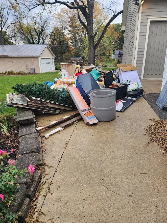 Dumpster being loaded with debris for 12 Yard Dumpster Rental in Canton